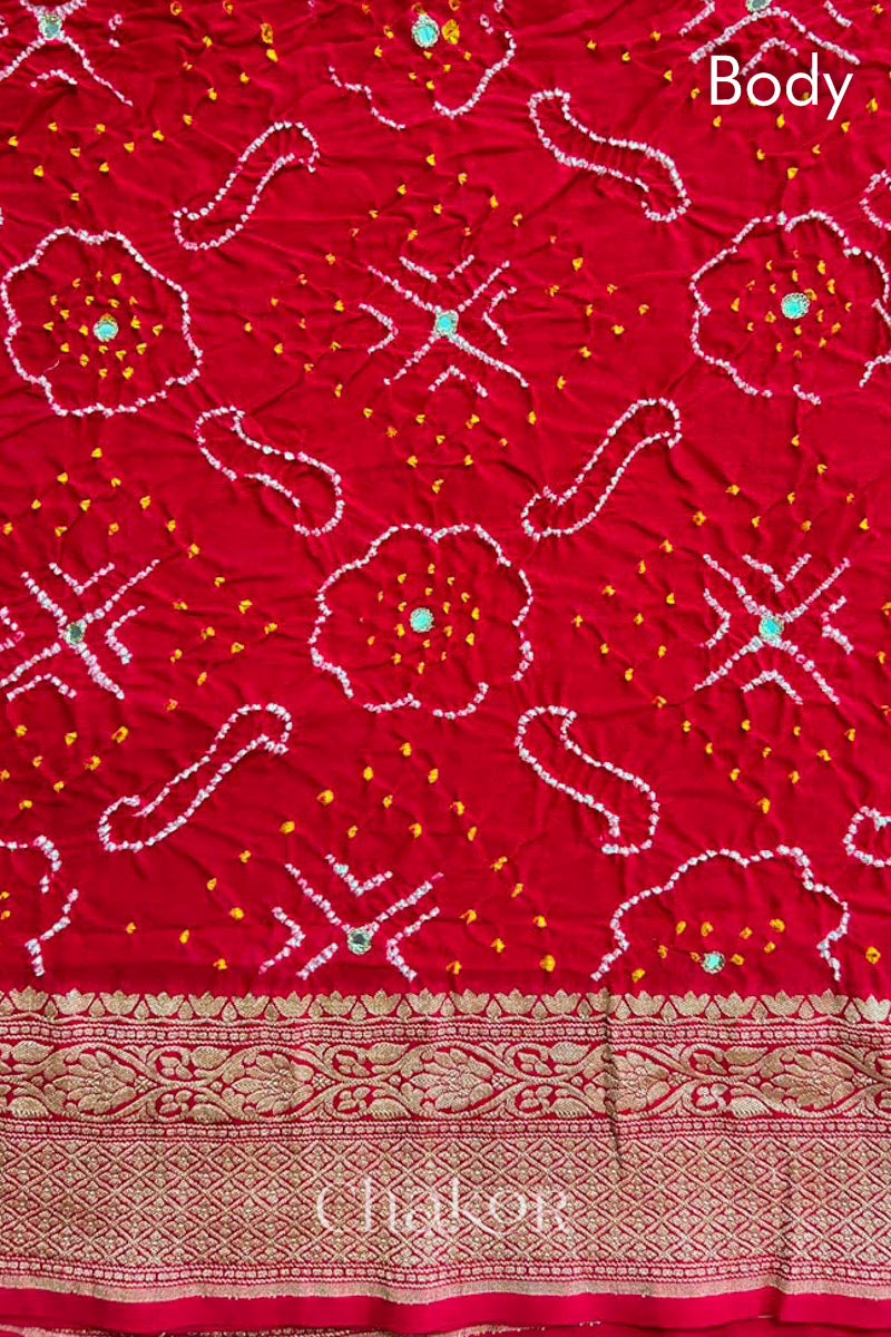 Close up of  Handcrafted Red Bandhani Banarasi Georgette Saree in pure silk featuring zari weaving and Kutch Bandhej with mirror embroidery, Perfect for wedding and occasions.
