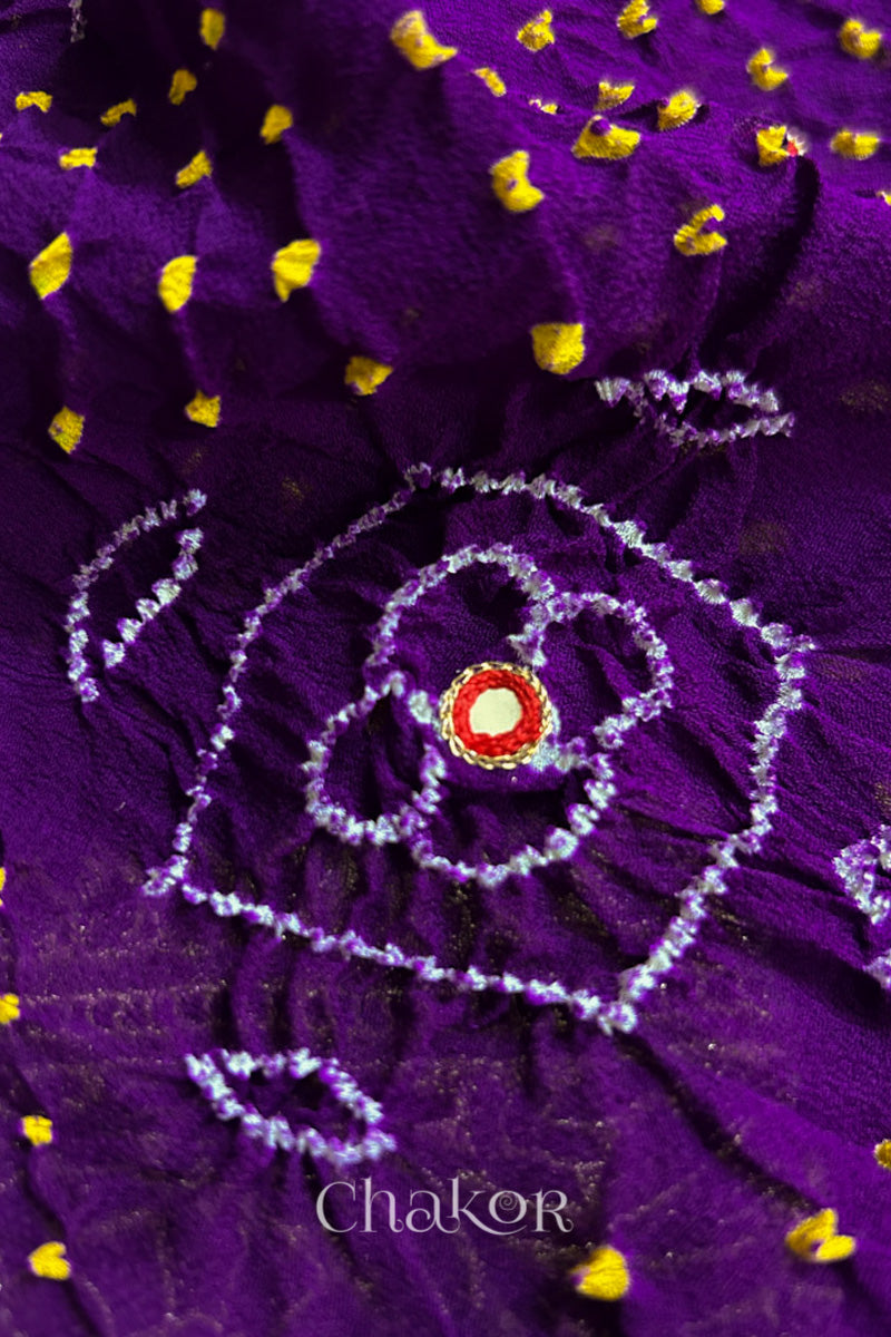 Close up of Handcrafted Purple Bandhani Banarasi Georgette Silk Saree featuring zari weaving and Kutch Bandhej with mirror embroidery.