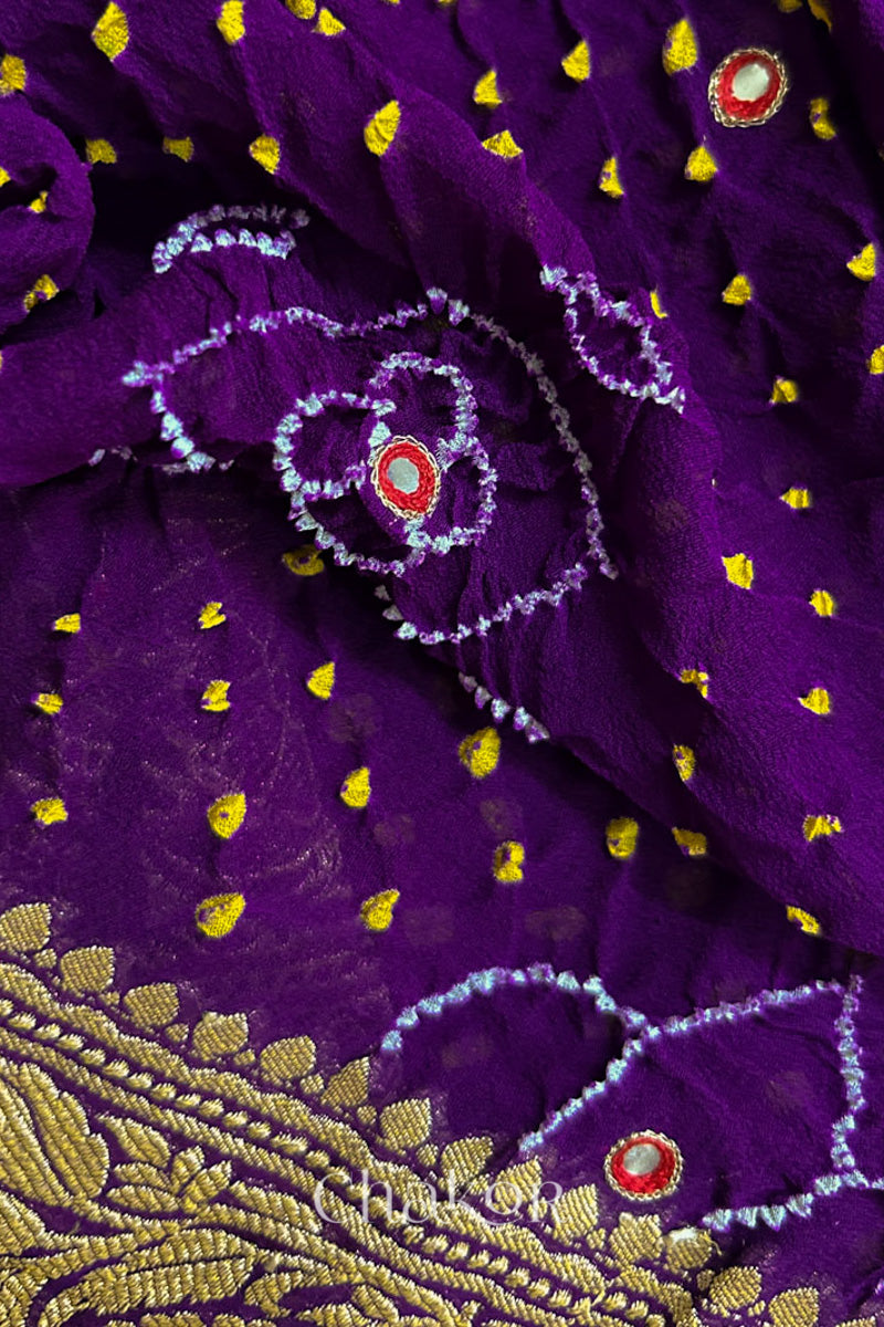 Close up of Handcrafted Purple Bandhani Banarasi Georgette Silk Saree featuring zari weaving and Kutch Bandhej with mirror embroidery.