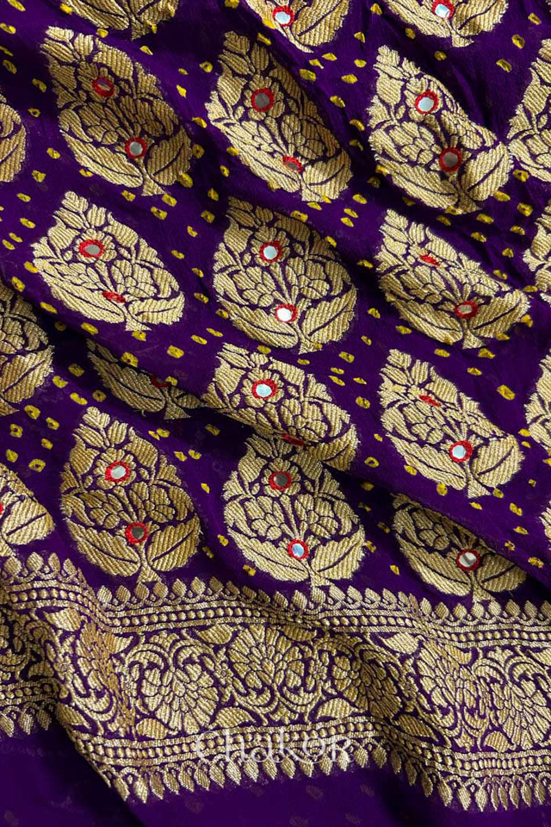 Close up of Handcrafted Purple Bandhani Banarasi Georgette Pure Silk Saree featuring zari weaving and Kutch Bandhej with mirror embroidery.