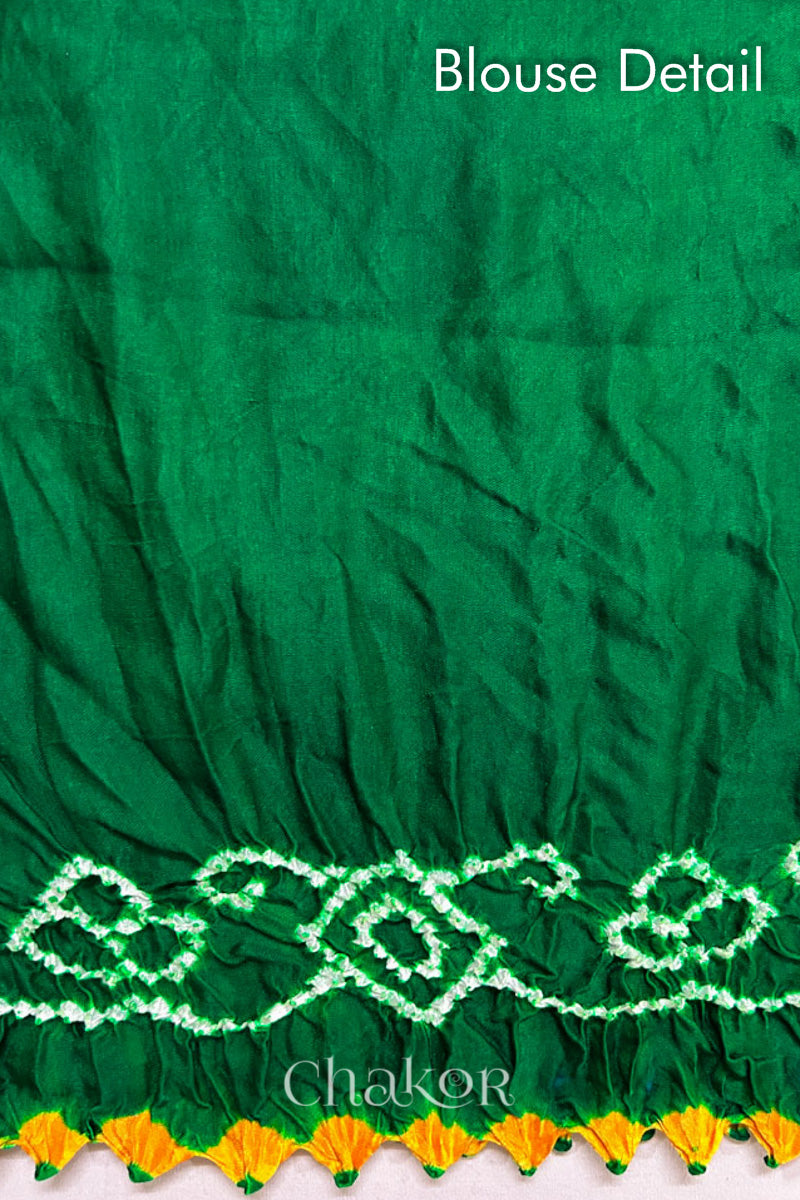 Close up of Handcrafted Parrot and green ombre Bandhani Gaji Silk Saree with traditional bandhej patterns and mukaish embroidery.