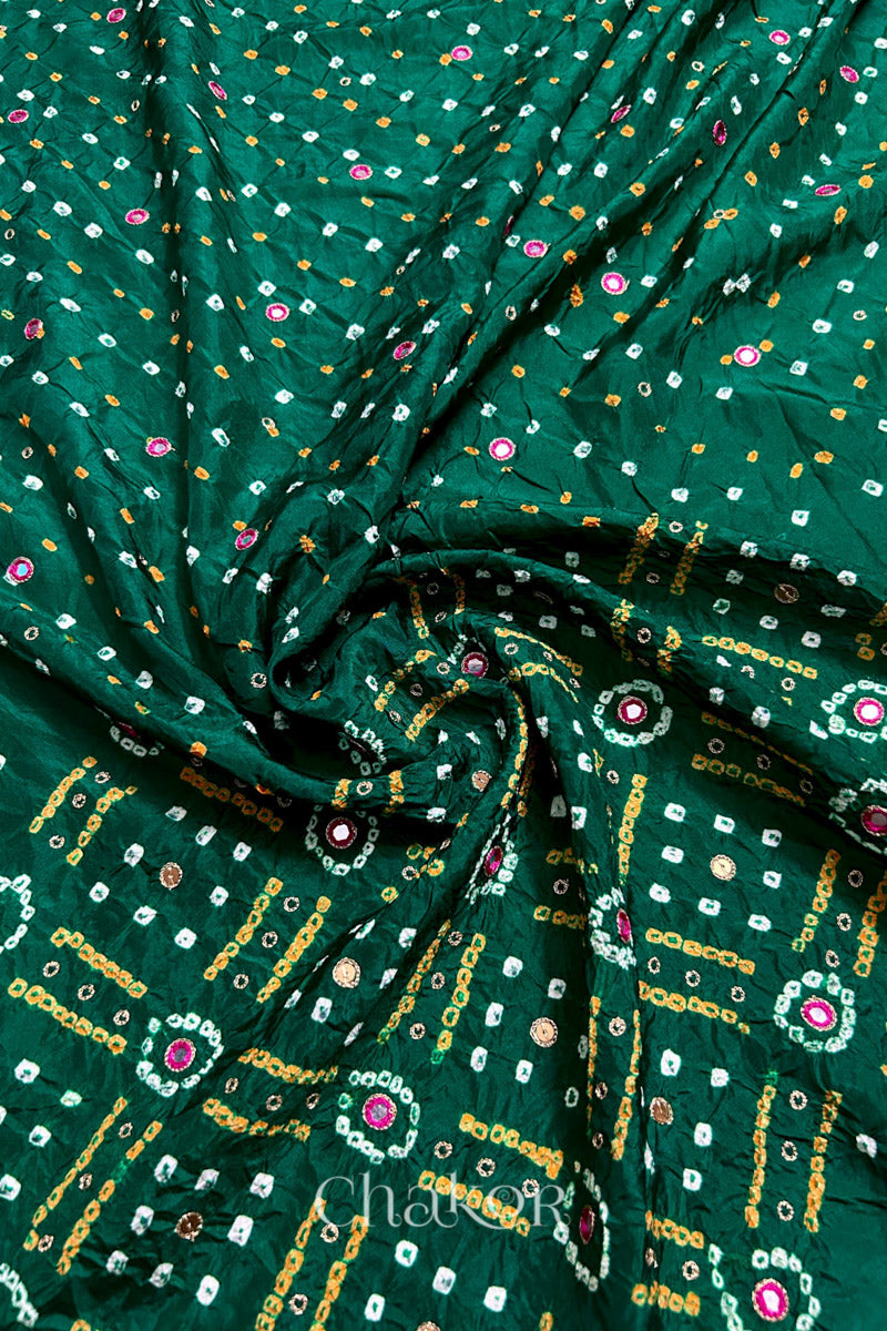 Green mulberry silk Bandhani (Rai Bandhej) fabric with white and yellow tie-dyed motifs, pink mirror and sequin embellishment, arranged in a swirling design  – CHAKOR.