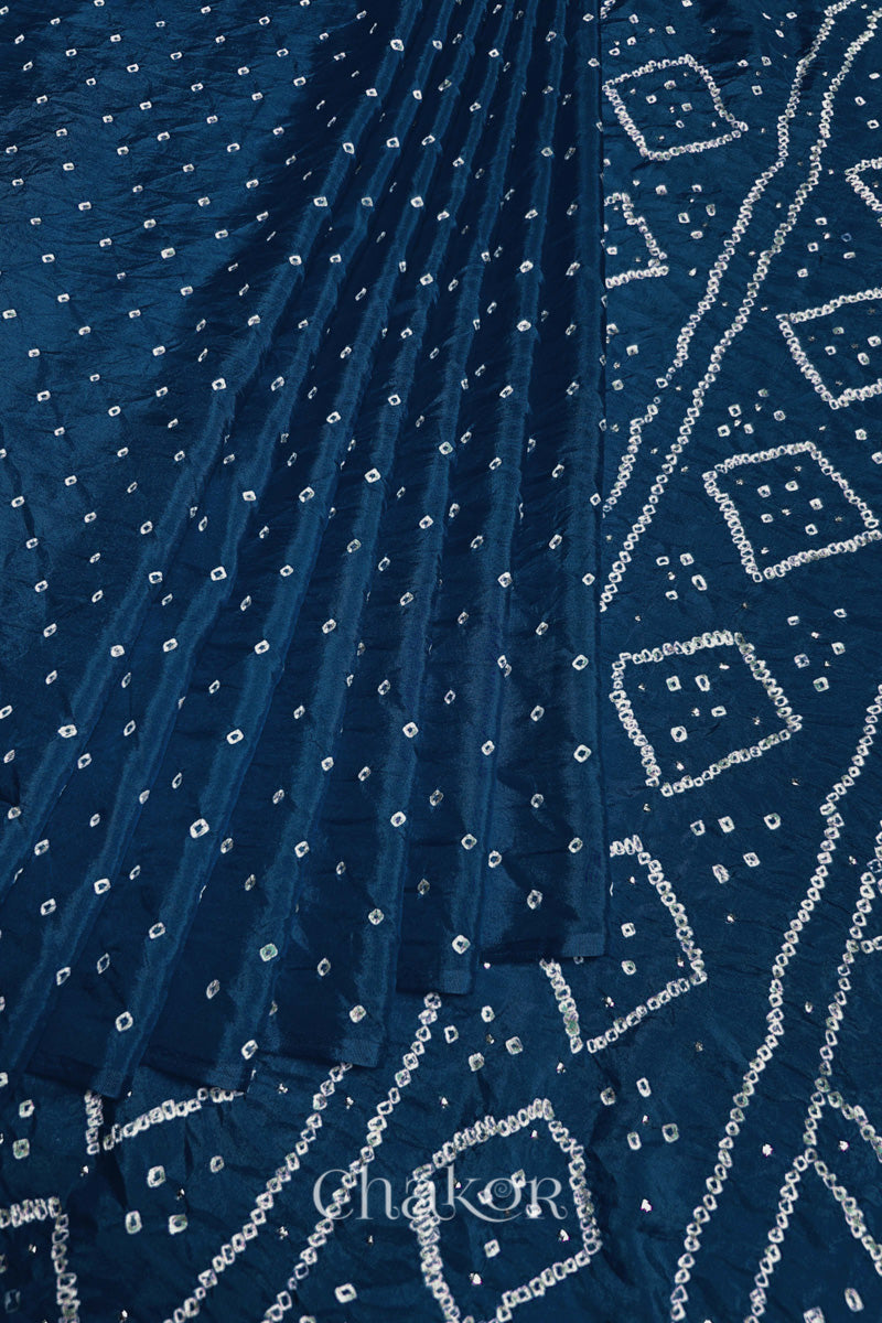 Pleated view of indigo blue Bandhani Mulberry Silk Saree, handcrafted in rai bandhej patterns with mukaish embroidery.