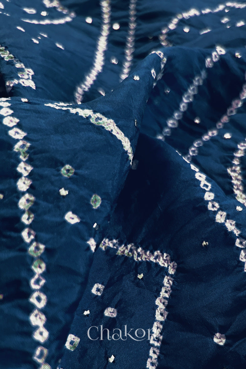Close up of indigo blue Bandhani Mulberry Silk Saree, handcrafted in rai bandhej patterns with mukaish embroidery.