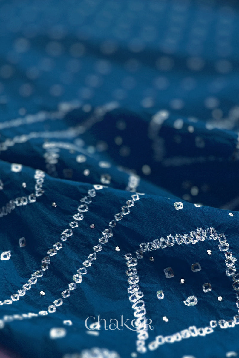 Close up of indigo blue Bandhani Mulberry Silk Saree, handcrafted in rai bandhej patterns with mukaish embroidery.