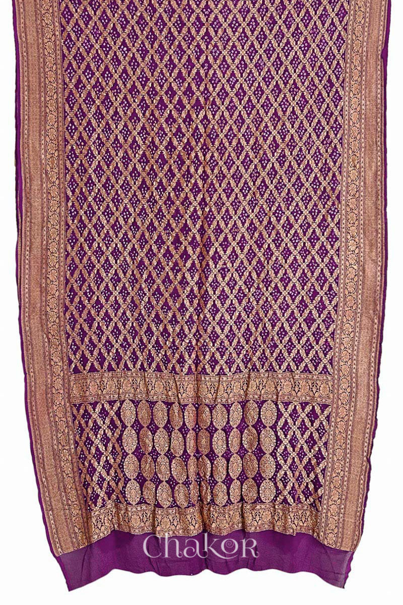 Woman wearing Handcrafted Purple Bandhani Banarasi Georgette Saree in pure silk featuring zari weaving and Kutch Bandhej for weddings and occasions.