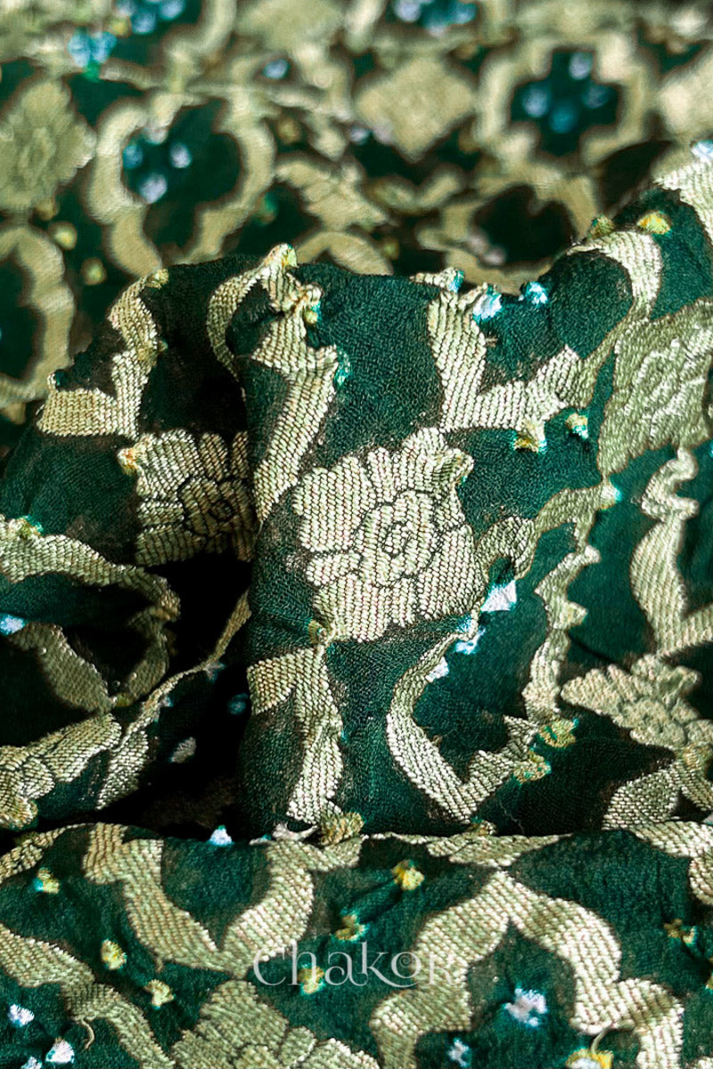 Close up of Handcrafted Green Bandhani Banarasi Georgette Saree in pure silk featuring zari weaving and Kutch Bandhej for weddings and occasions.