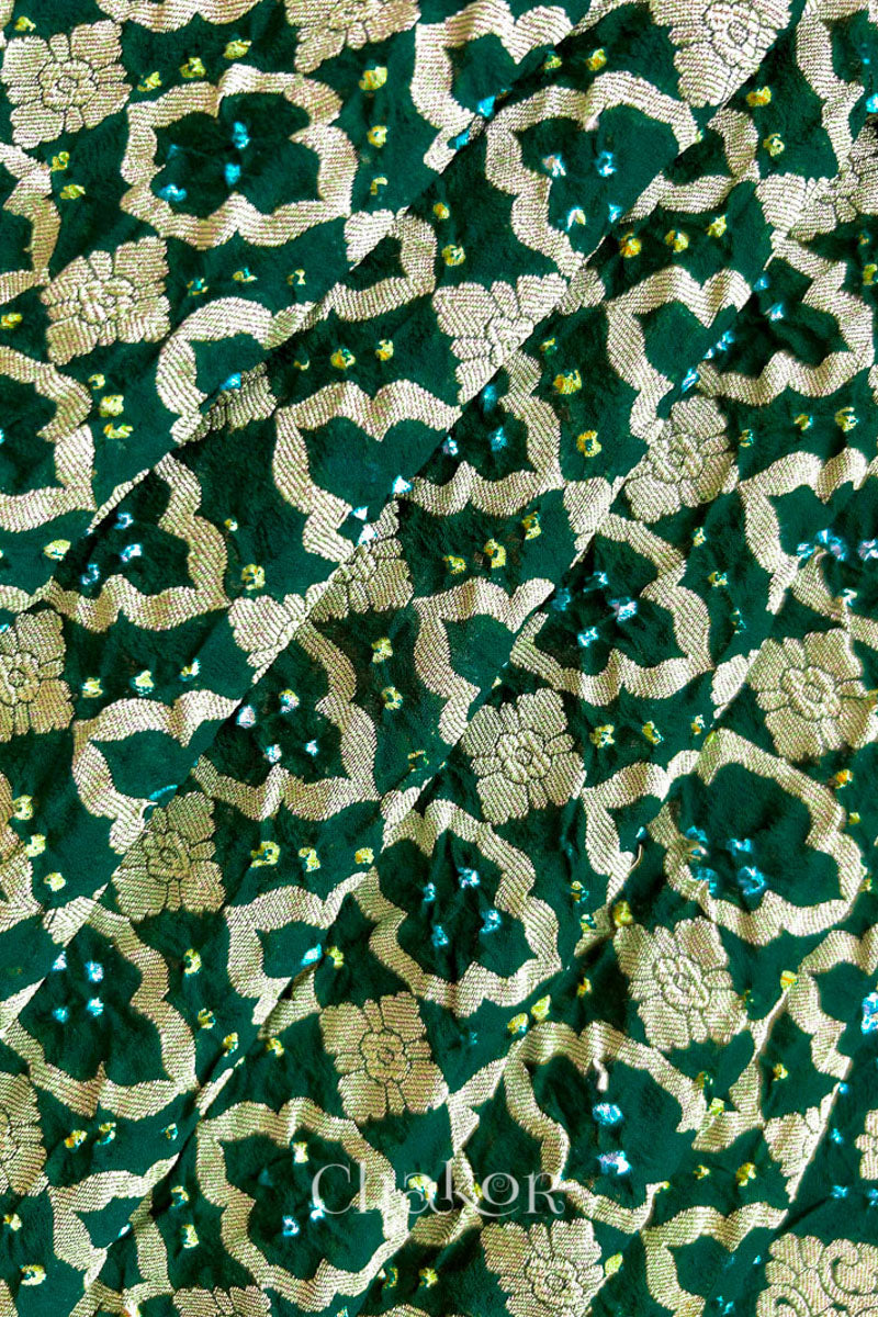 Close up of Handcrafted Green Bandhani Banarasi Georgette Saree in pure silk featuring zari weaving and Kutch Bandhej for weddings and occasions.