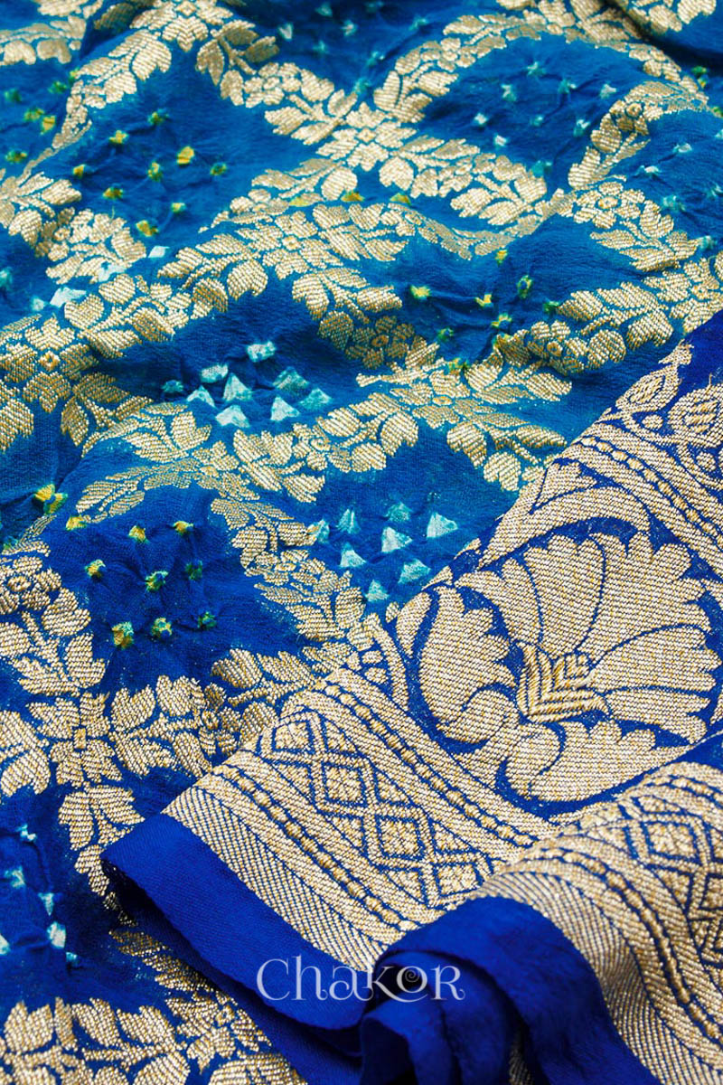Close up of Handcrafted Peacock Blue  Bandhani Banarasi Georgette Silk Saree featuring zari weaving and Kutch rai bandhej.