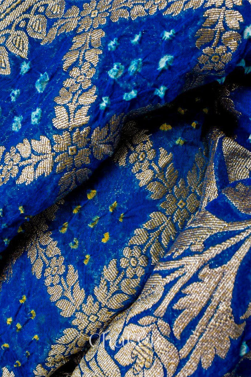 Close up of Handcrafted Peacock Blue  Bandhani Banarasi Georgette Silk Saree featuring zari weaving and Kutch rai bandhej.