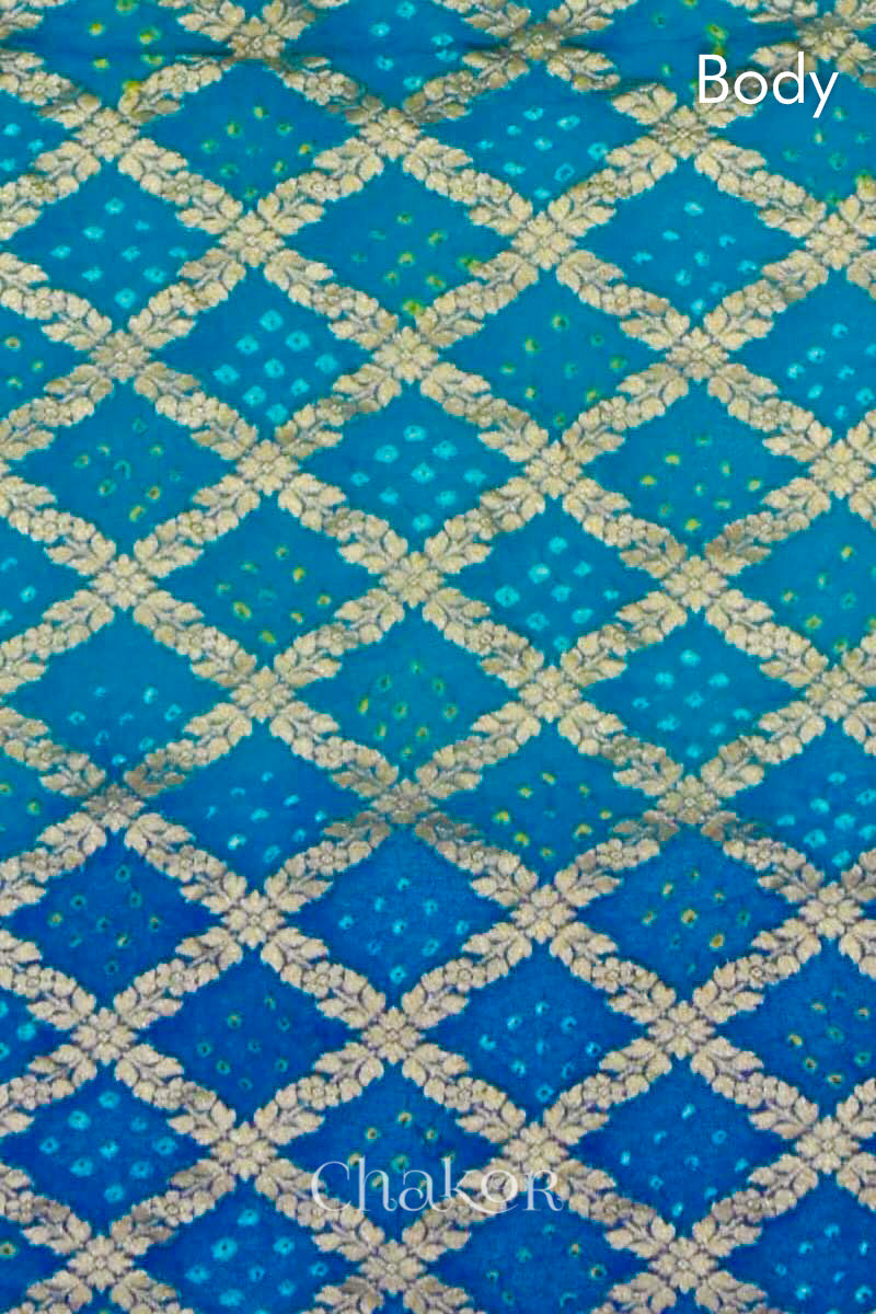 Close up of Handcrafted Peacock Blue  Bandhani Banarasi Georgette Silk Saree featuring zari weaving and Kutch rai bandhej.