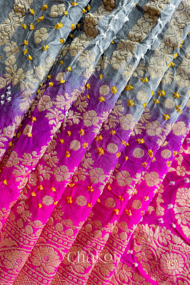 Close up of Handcrafted Pink and grey ombre shaded Bandhani Banarasi Georgette Silk Saree featuring zari weaving and Kutch Bandhej.
