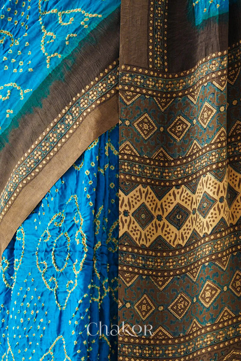 Close up of Peacock Blue Bandhani Saree with Brown Ajrakh printed border and pallu in pure gaji silk with traditional bandhej tie-dye, handcrafted in Kutch. 