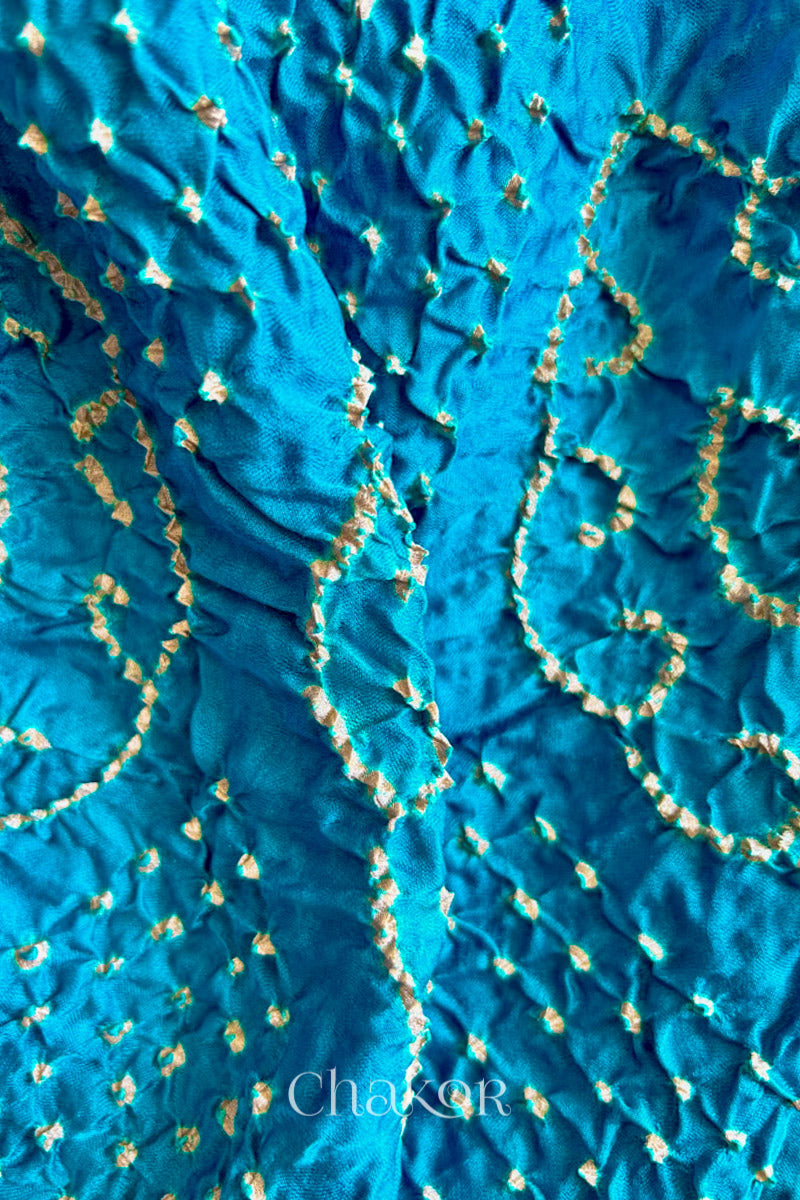 Close up of Peacock Blue Bandhani Saree with Brown Ajrakh printed border and pallu in pure gaji silk with traditional bandhej tie-dye, handcrafted in Kutch. 