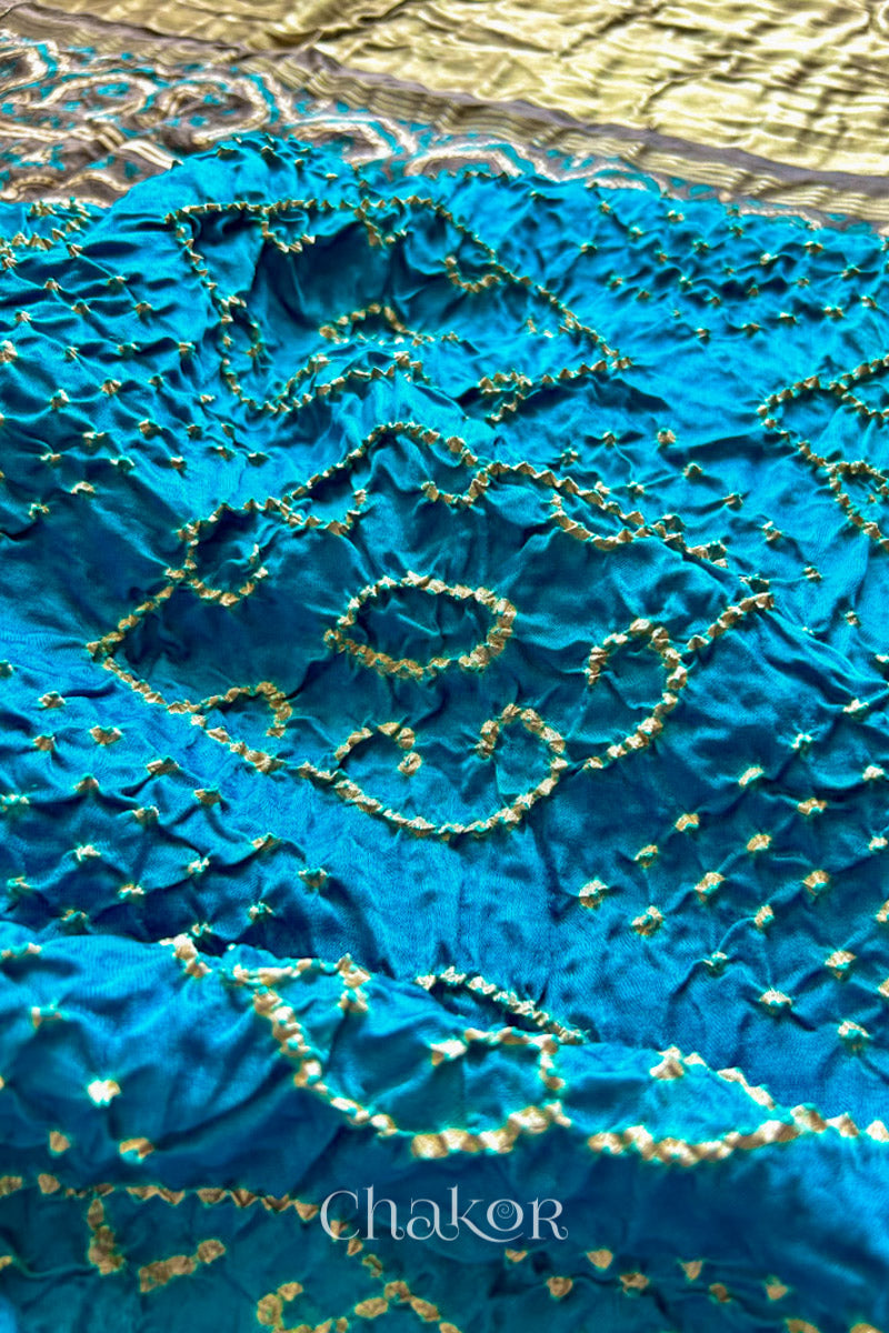 Close up of Peacock Blue Bandhani Saree with Brown Ajrakh printed border and pallu in pure gaji silk with traditional bandhej tie-dye, handcrafted in Kutch. 