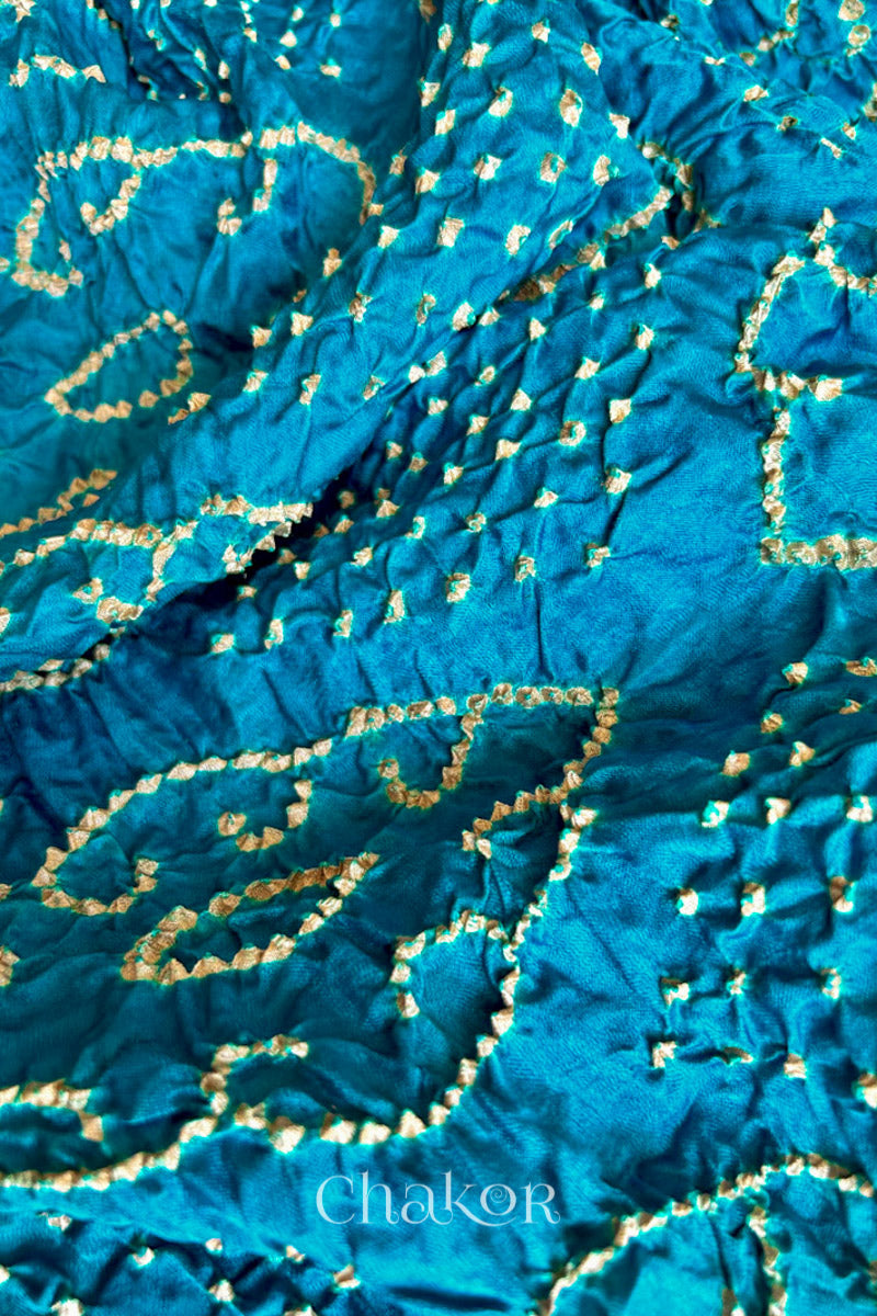 Close up of Peacock Blue Bandhani Saree with Brown Ajrakh printed border and pallu in pure gaji silk with traditional bandhej tie-dye, handcrafted in Kutch. 