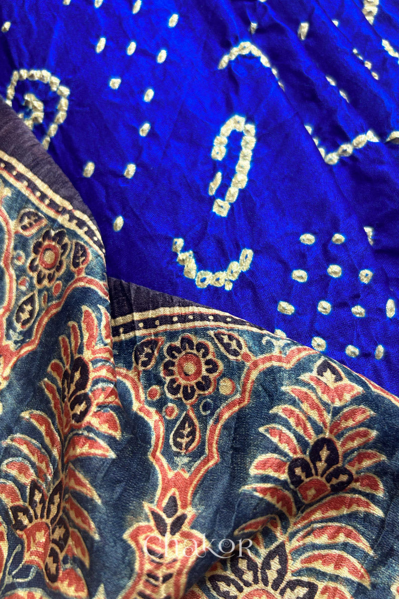Close up of Blue Red Bandhani Ajrakh Silk Saree with intricate bandhani motifs and a zari stripe pallu, hand block printed using natural dyes on luxurious gaji silk fabric.