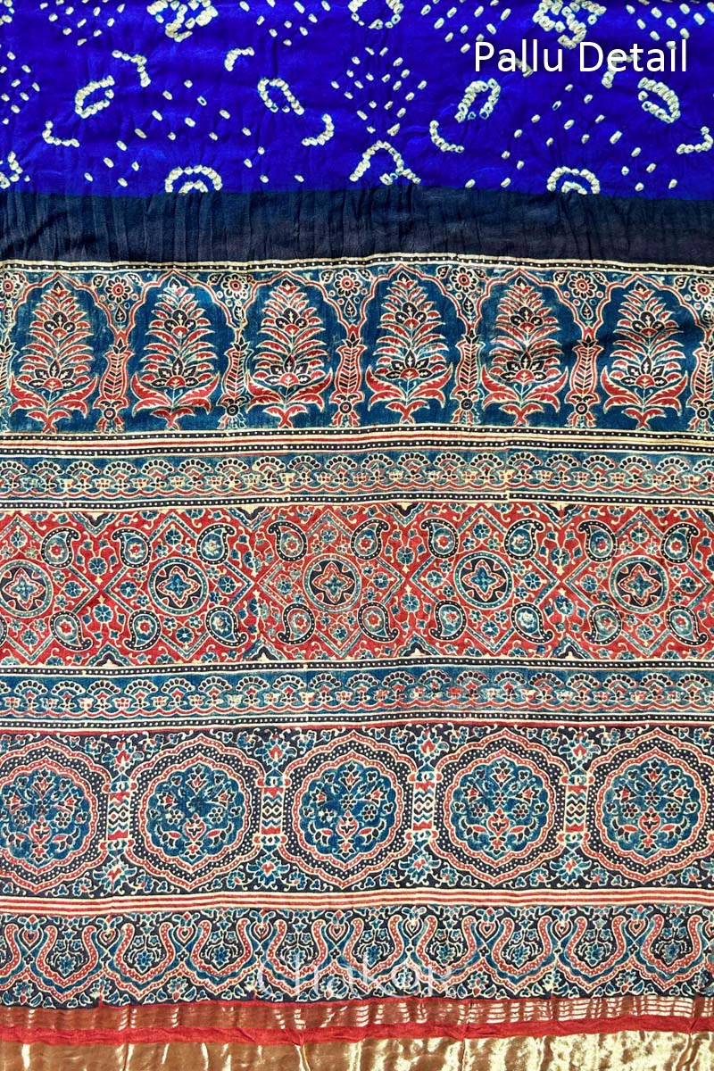 A Blue Red Bandhani Ajrakh Silk Saree with intricate bandhani motifs and a zari stripe pallu, hand block printed using natural dyes on luxurious gaji silk fabric.