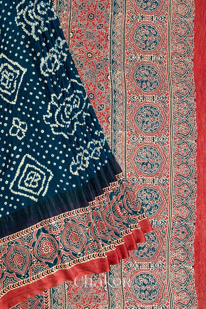Close up of Navy Bandhani Saree with Red Ajrakh printed border and pallu in pure gaji silk with traditional bandhej tie-dye, handcrafted in Kutch. 