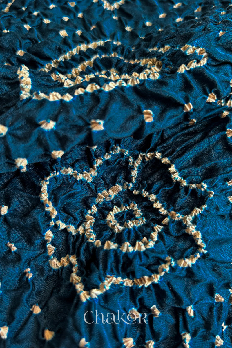 Close up of Navy Bandhani Saree with Red Ajrakh printed border and pallu in pure gaji silk with traditional bandhej tie-dye, handcrafted in Kutch. 