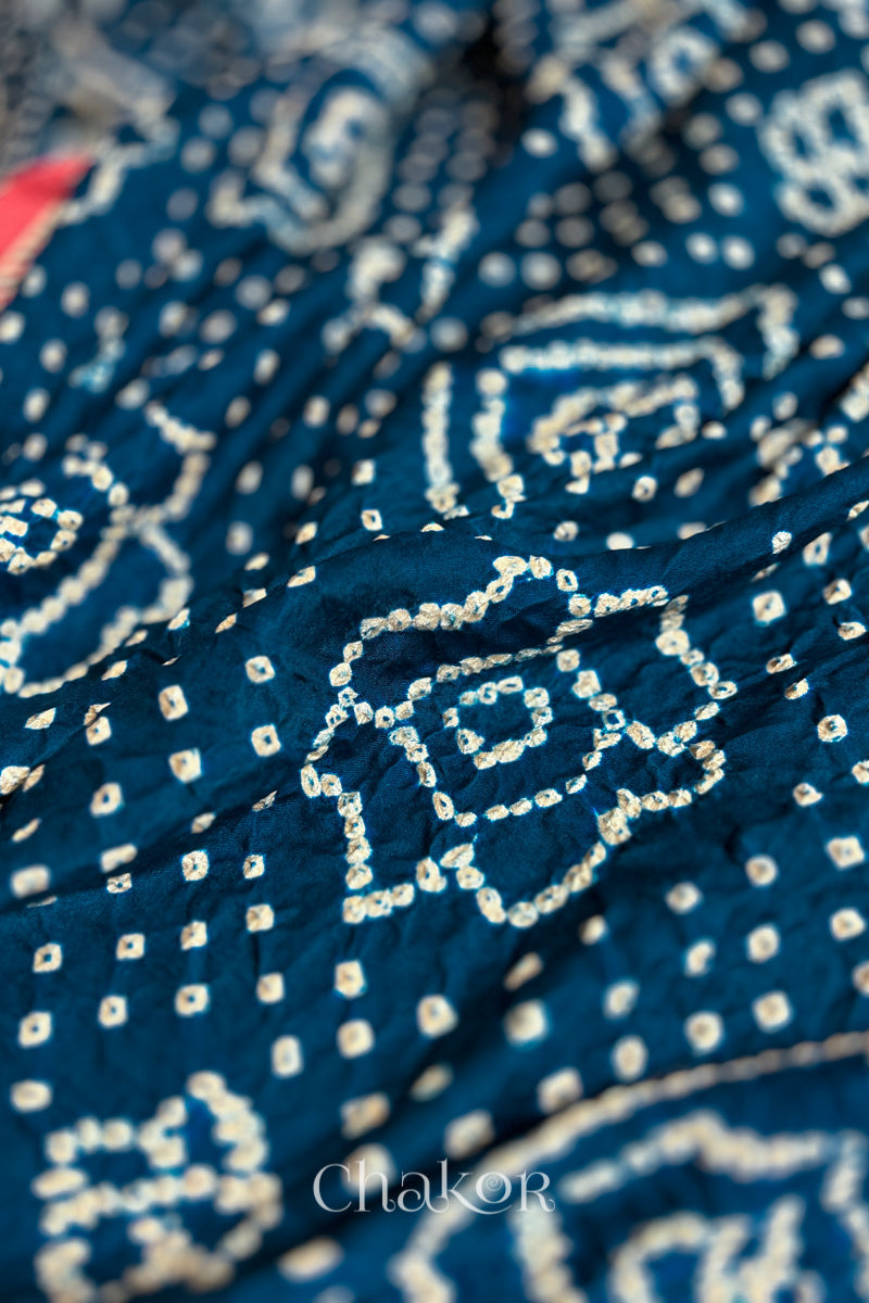 Close up of Navy Bandhani Saree with Red Ajrakh printed border and pallu in pure gaji silk with traditional bandhej tie-dye, handcrafted in Kutch. 
