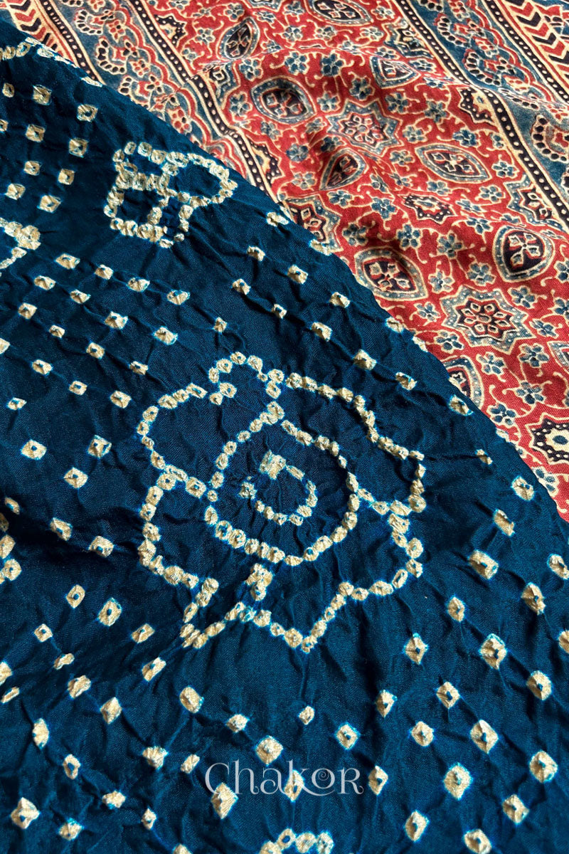 Close up of Navy Bandhani Saree with Red Ajrakh printed border and pallu in pure gaji silk with traditional bandhej tie-dye, handcrafted in Kutch. 