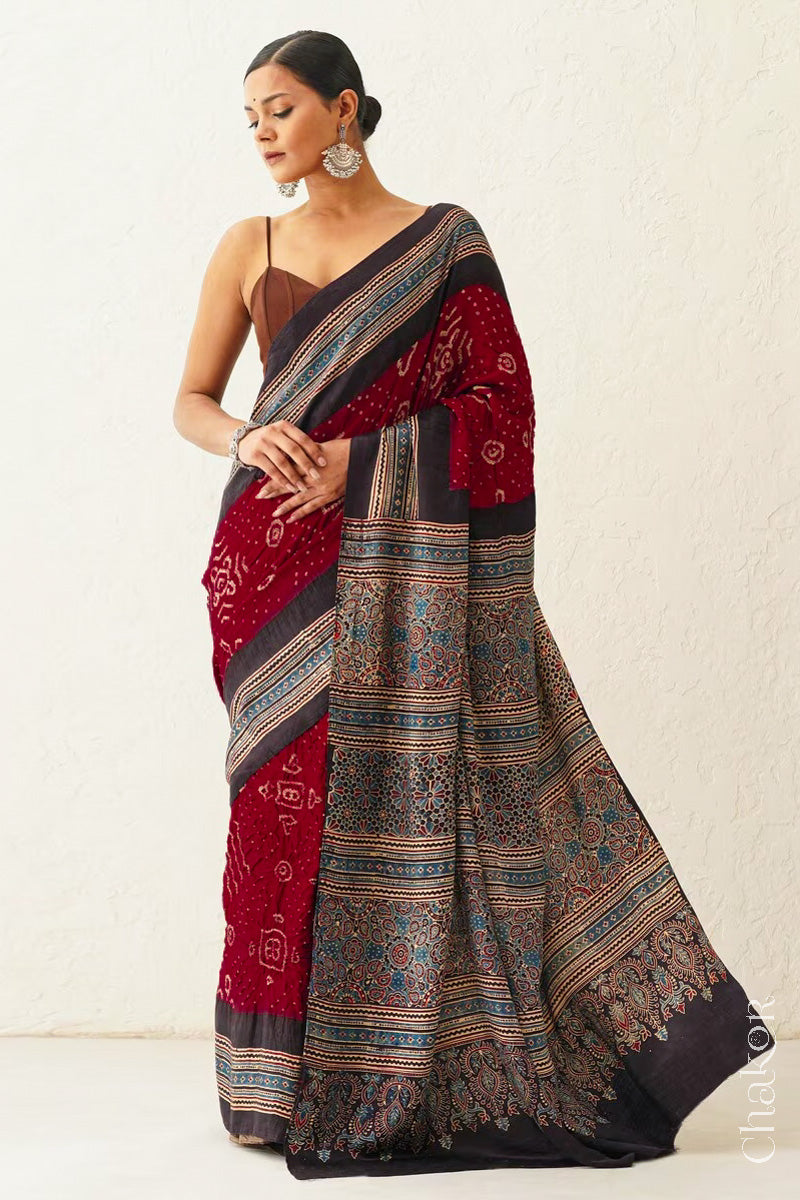 Close up of Maroon Bandhani Saree with Black Ajrakh printed border and pallu in pure gaji silk with traditional bandhej tie-dye, handcrafted in Kutch. 