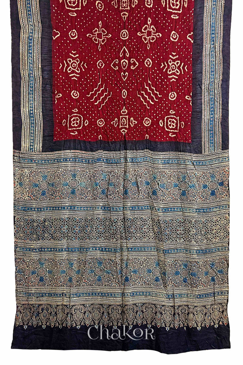 Full view of Maroon Bandhani Saree with Black Ajrakh printed border and pallu in pure gaji silk with traditional bandhej tie-dye, handcrafted in Kutch. 