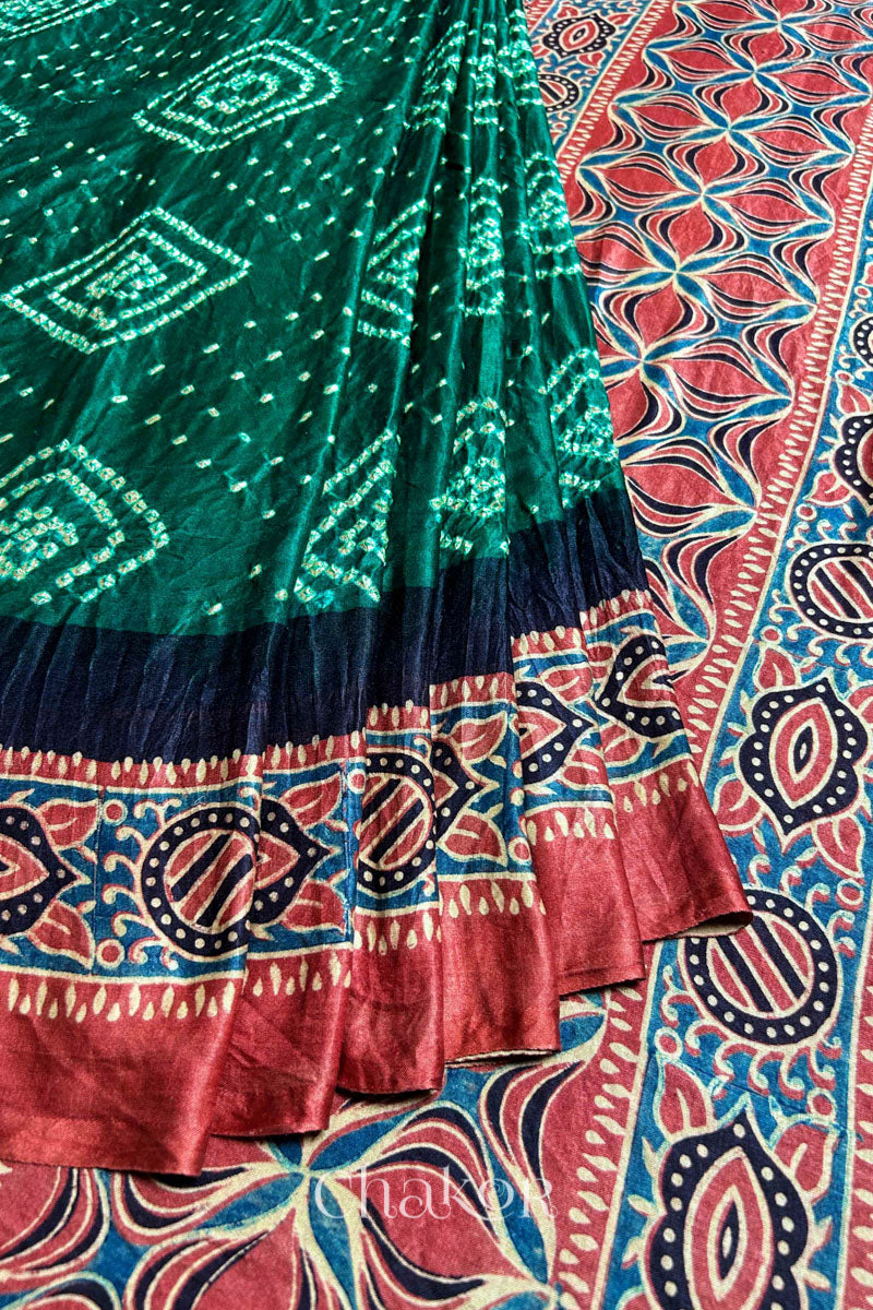 Close up of Green Bandhani Saree with Ajrakh printed border and pallu in pure gaji silk with traditional bandhej tie-dye, handcrafted in Kutch. 