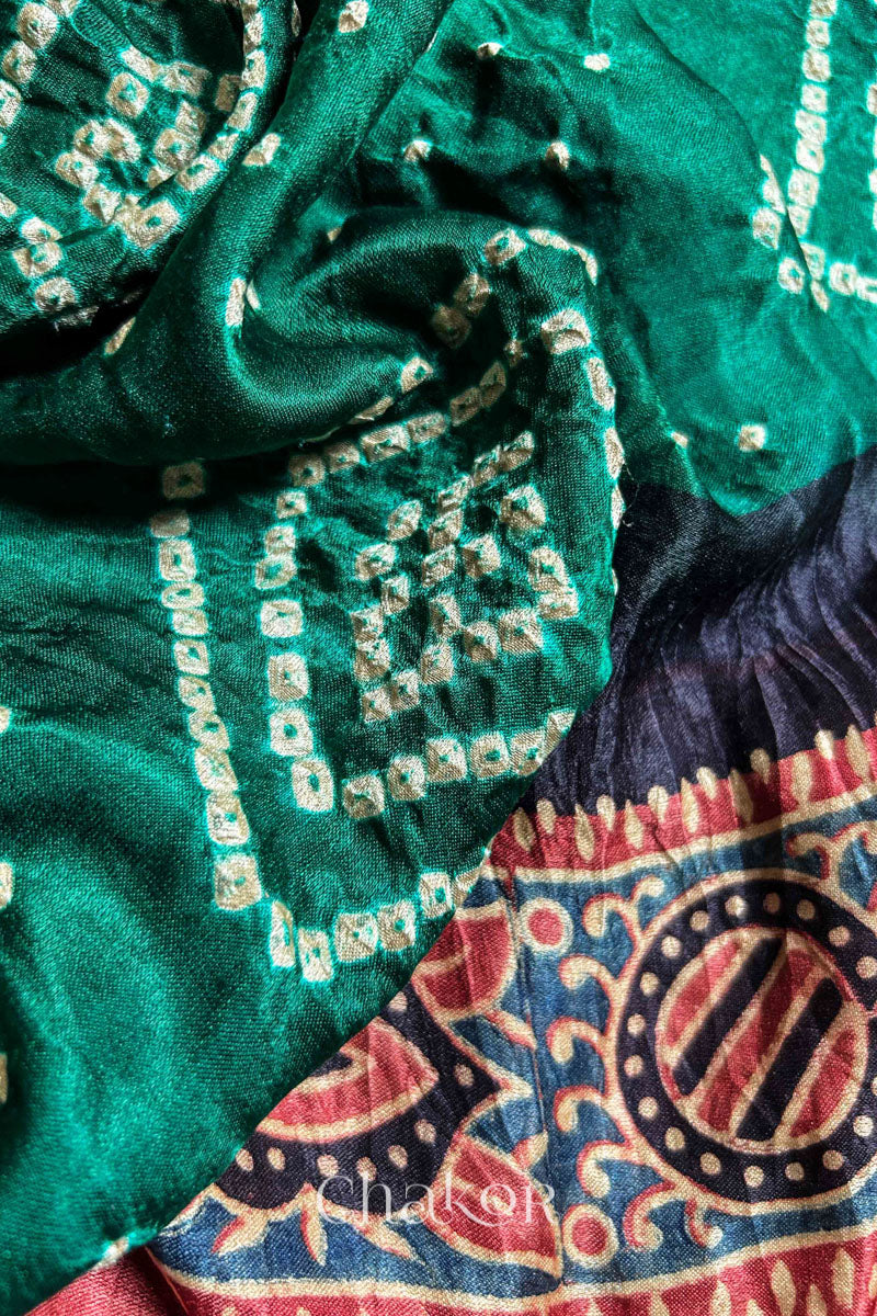 Close up of Green Bandhani Saree with Ajrakh printed border and pallu in pure gaji silk with traditional bandhej tie-dye, handcrafted in Kutch. 