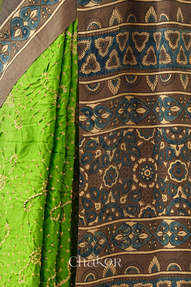 Close up of Parrot green Bandhani Saree with Brown Ajrakh printed border and pallu in pure gaji silk with traditional bandhej tie-dye, handcrafted in Kutch. 