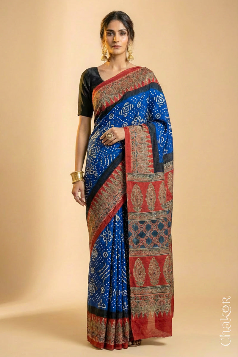 Woman wearing Blue Bandhani Saree with Natural Red Ajrakh printed border and pallu in pure gaji silk with traditional bandhej tie-dye, handcrafted in Kutch. 