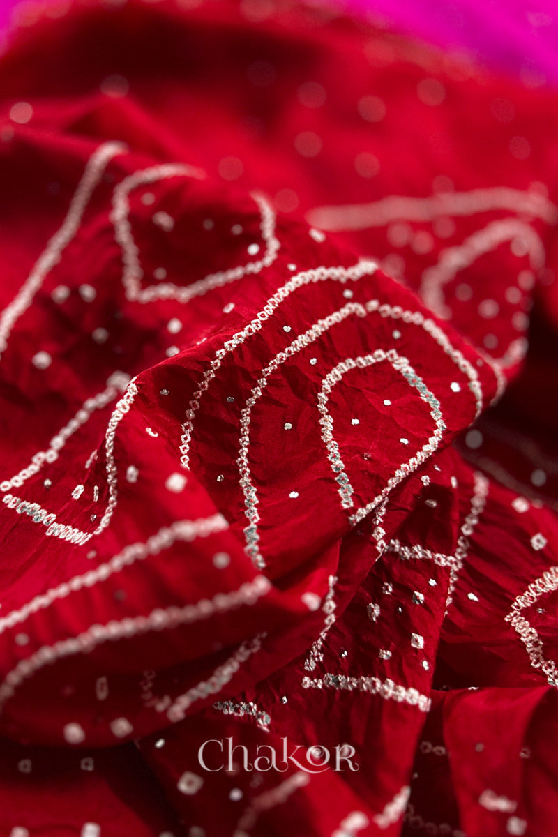 Close up  of Red Bandhani Mulberry Silk Saree, handcrafted in rai bandhej patterns with mukaish embroidery.
