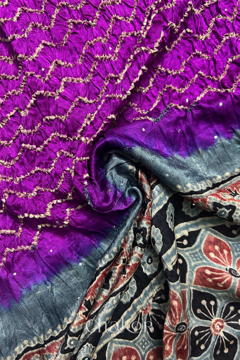 Draped detail view of magenta Bandhani gaji silk dupatta showing body pattern and Ajrakh pallu.