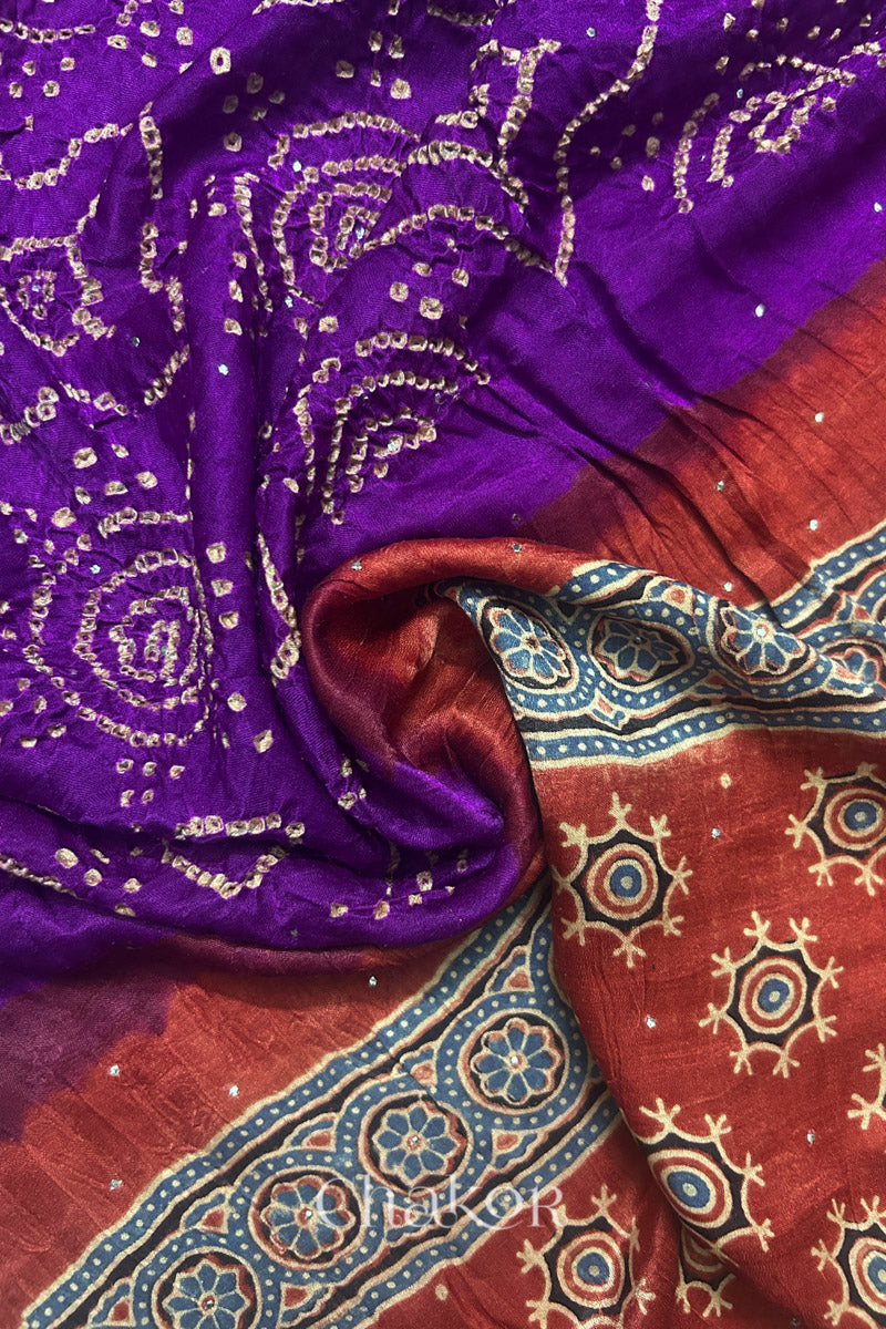 Draped detail view of purple Bandhani gaji silk dupatta showing body pattern and madder red Ajrakh pallu.