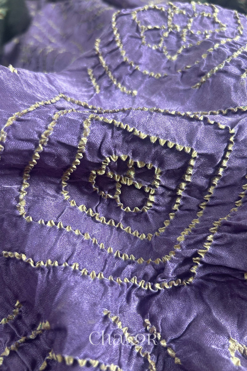 Close up of Mauve Bandhani Saree with Natural Black Ajrakh printed border and pallu in pure gaji silk with traditional bandhej tie-dye, handcrafted in Kutch. 