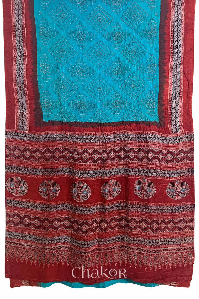 Full view of Peacock Blue Bandhani Saree with Natural Red Ajrakh printed border and pallu in pure gaji silk with traditional bandhej tie-dye, handcrafted in Kutch. 