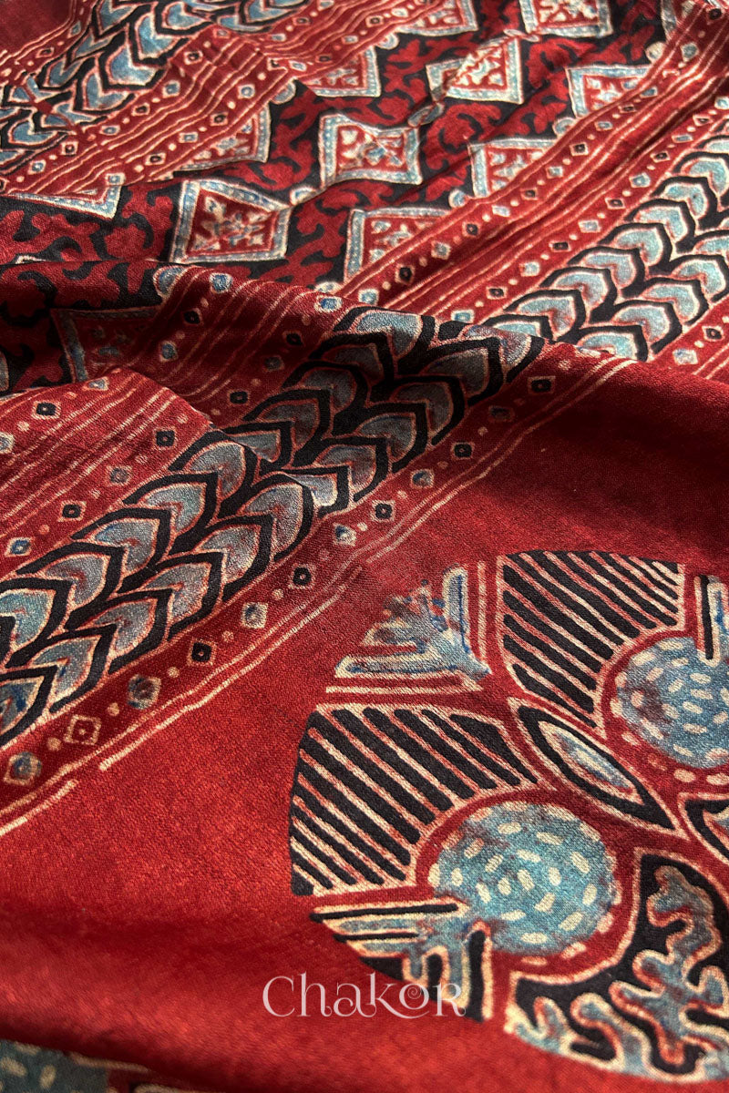 Close up of Peacock Blue Bandhani Saree with Natural Red Ajrakh printed border and pallu in pure gaji silk with traditional bandhej tie-dye, handcrafted in Kutch. 