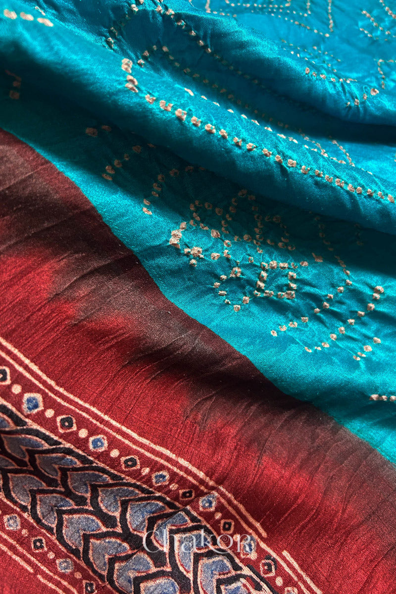 Close up of Peacock Blue Bandhani Saree with Natural Red Ajrakh printed border and pallu in pure gaji silk with traditional bandhej tie-dye, handcrafted in Kutch. 
