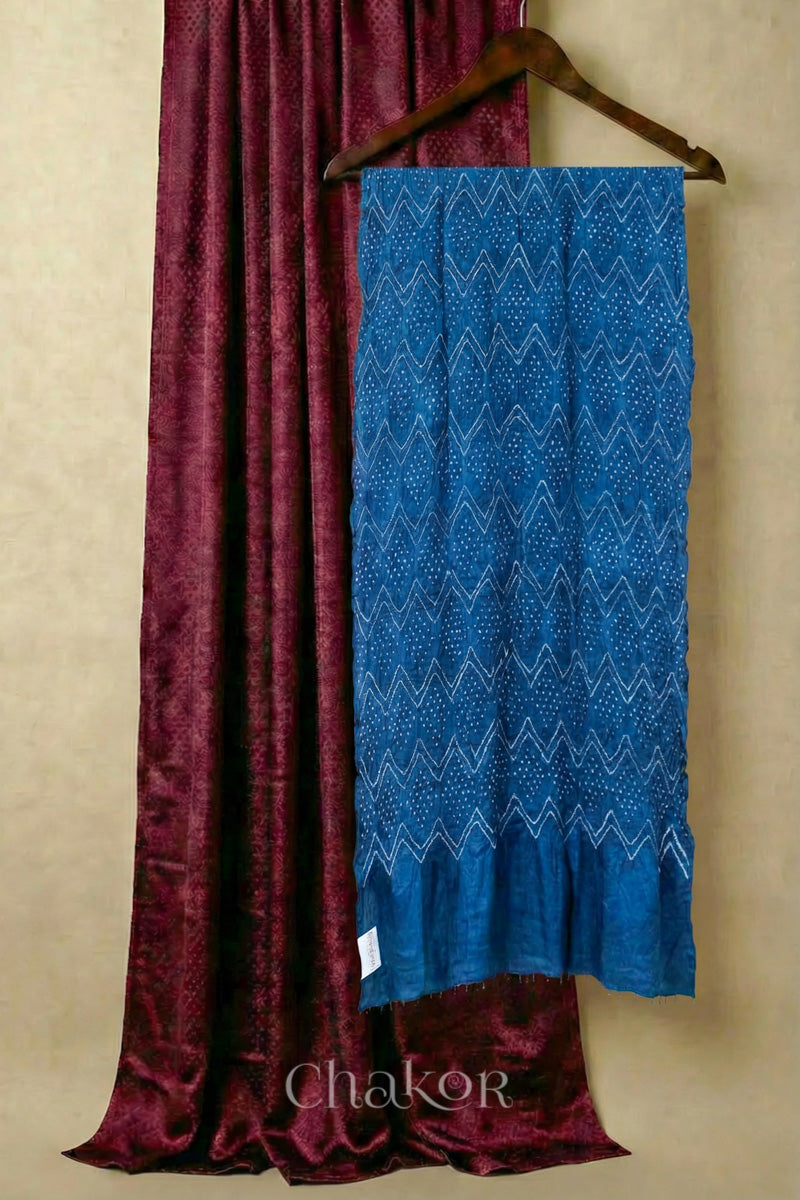Maroon mashru silk kurta set fabric paired with blue bandhani gaji silk dupatta featuring beads on edge.
