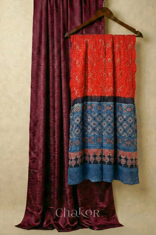 Maroon mashru silk kurta set fabric paired with orange indigo bandhani gaji silk dupatta featuring ajrakh printed pallu.