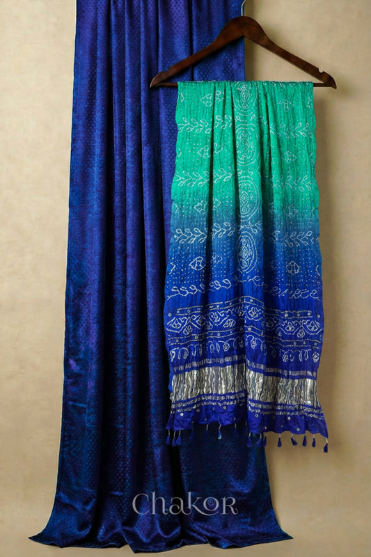 Royal Blue mashru silk kurta set fabric paired with sea green blue ombre bandhani gaji silk dupatta featuring golden zari pallu & embellished with mirrors & edged with tassels.