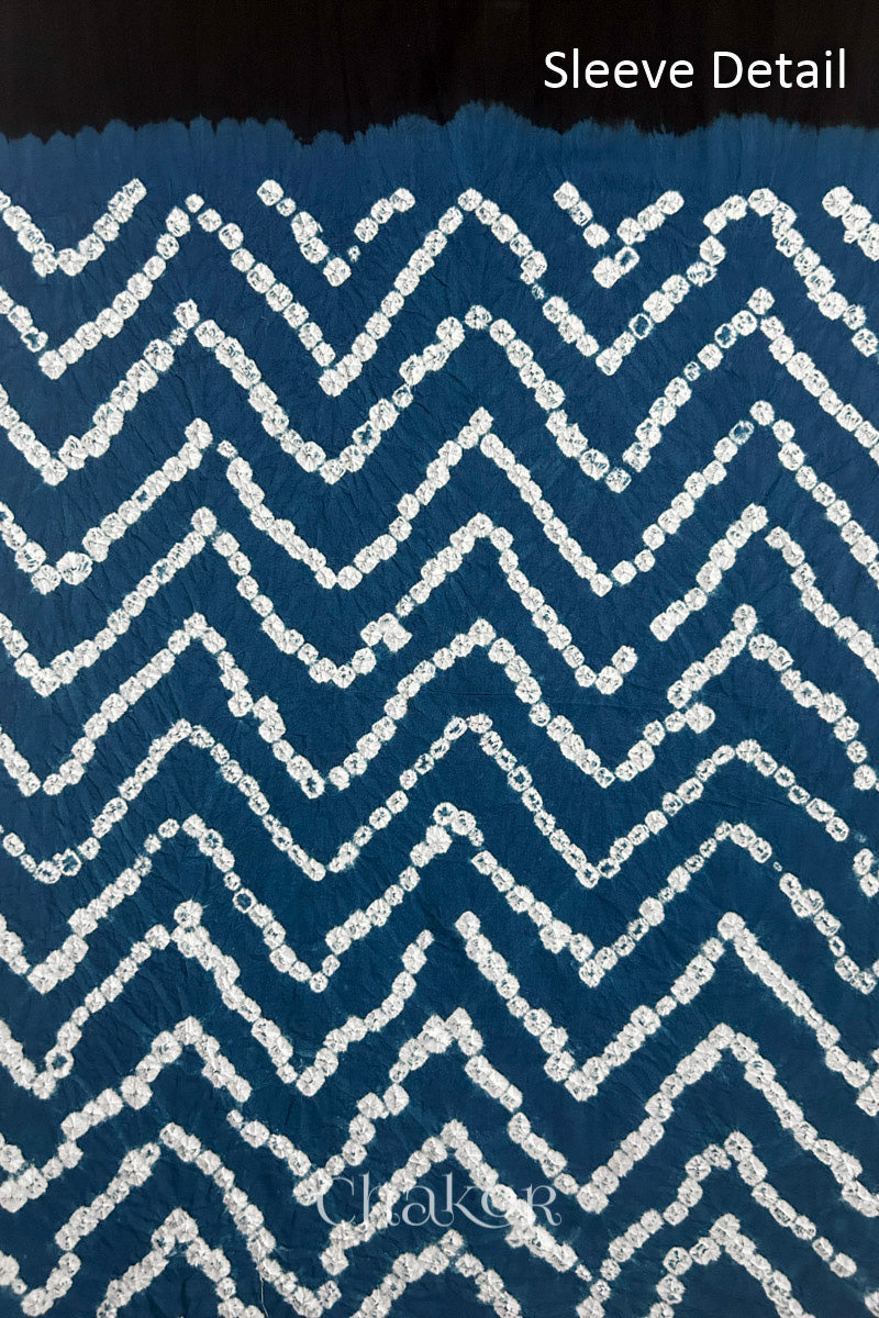 Close-up of  black bandhani fabric featuring chevron tie-dye design, with Chakor brand logo. Text reads sleeve details.
