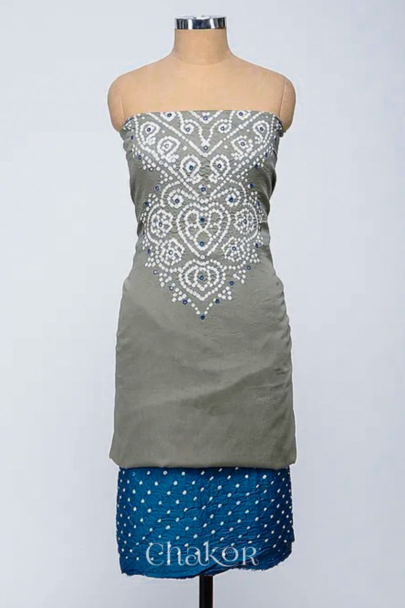 A stylish fabric featuring a cement grey mirror embroideindigo blue top, a bandhani indigo blue bottom. Text reads Chakor.
