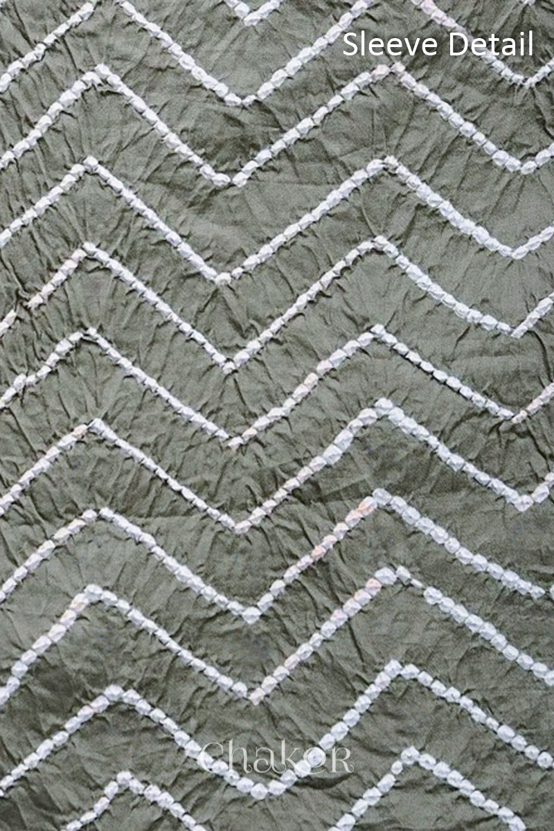 Close-up of bandhani sleeve detail featuring chevron tie-dye design, with Chakor brand logo.

