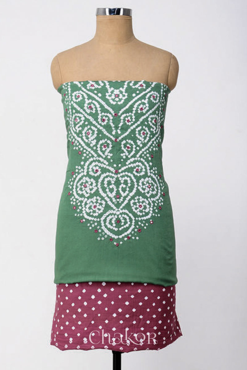 A stylish fabric featuring a moss green mirror embroidered plum pink top, a bandhani plum pink bottom. Text reads Chakor.
