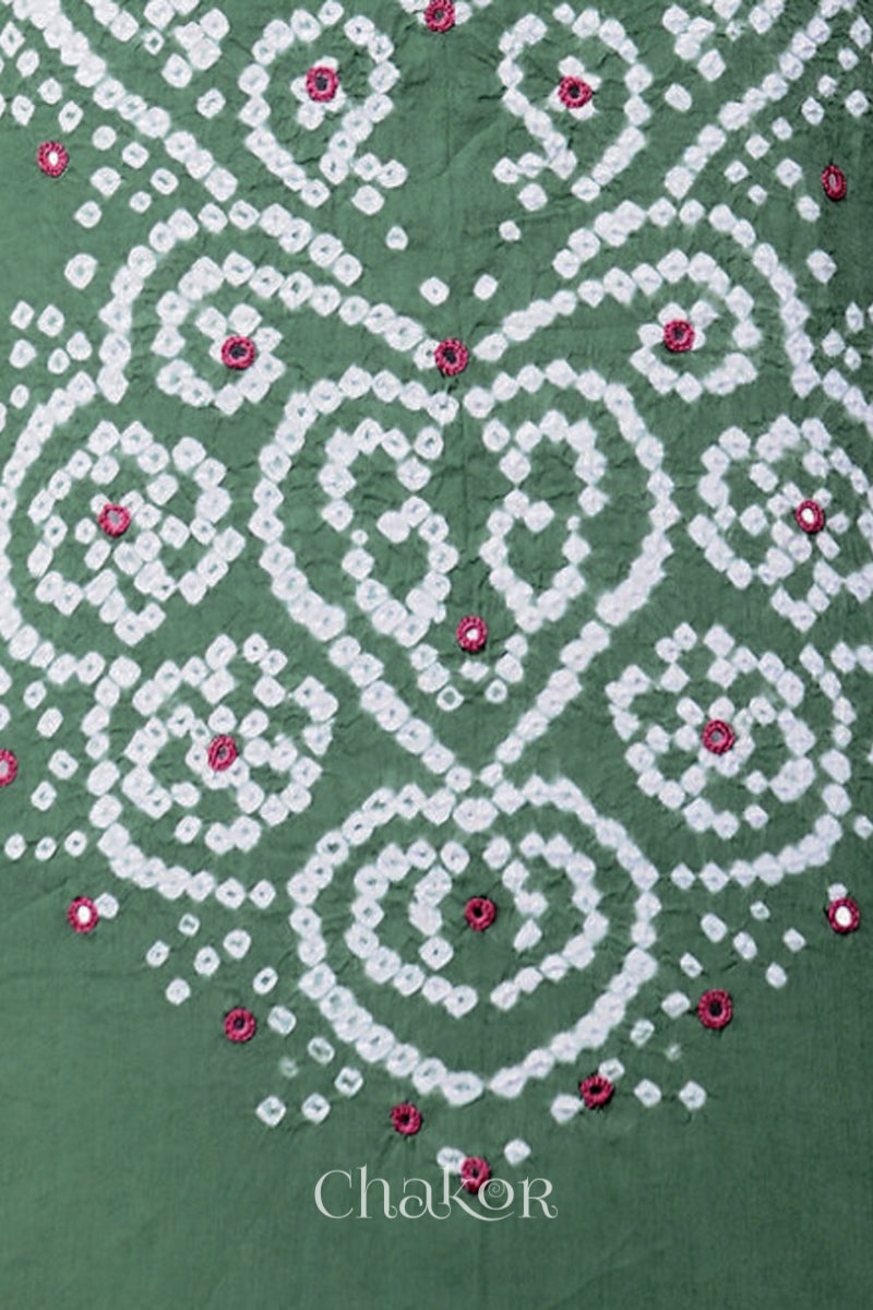 Close-up of bandhani yoke kurta fabric featuring floral & spiral tie-dye design and plum pink mirror embroidery, with Chakor brand logo.
