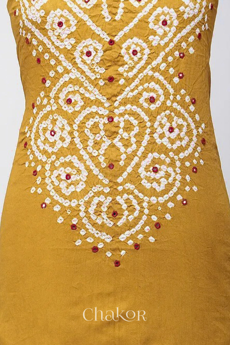 Close-up of bandhani yoke kurta fabric featuring floral & spiral tie-dye design and red mirror embroidery, with Chakor brand logo.
