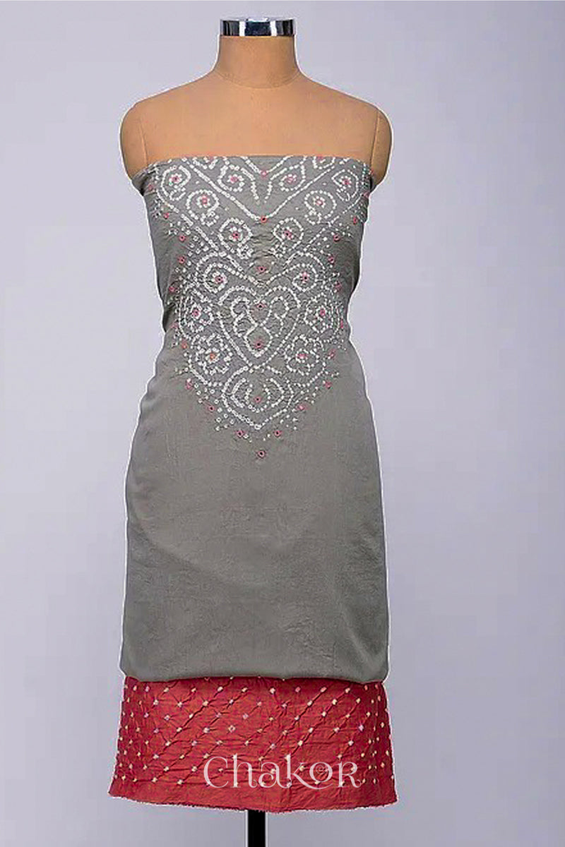 A stylish fabric featuring a grey mirror embroidered top, a bandhani dusty red bottom. Text reads Chakor.
