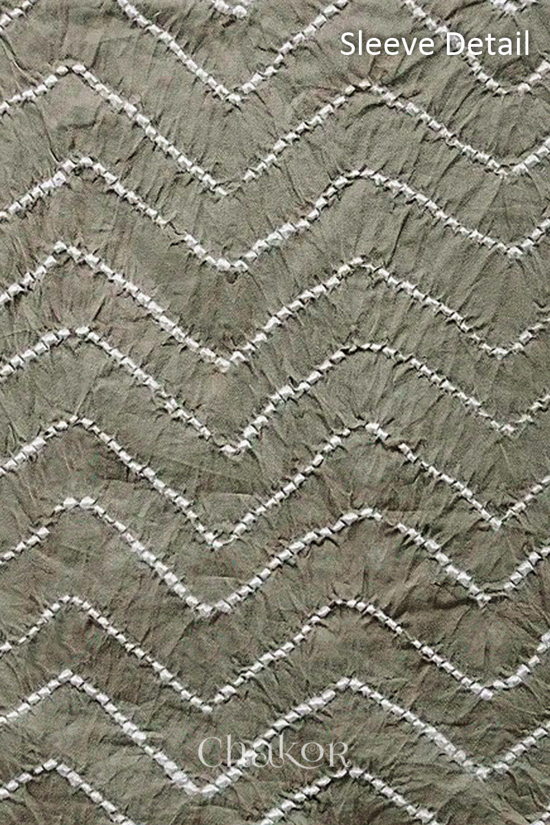 Close-up of bandhani sleeve detail featuring chevron tie-dye design, with Chakor brand logo.
